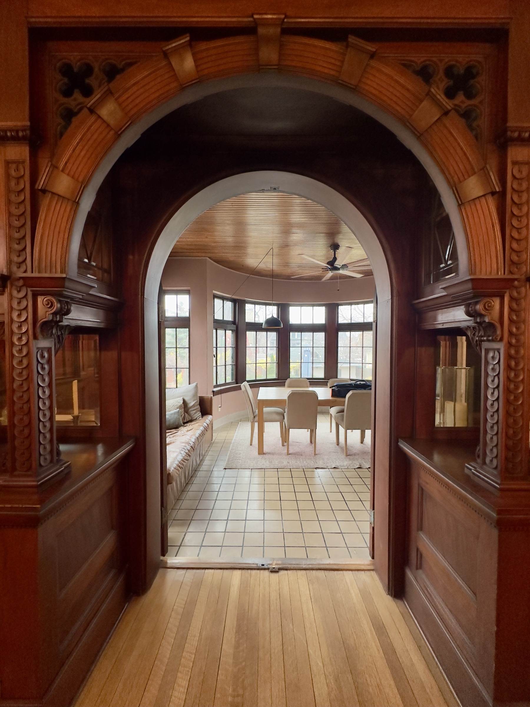 Gothic arch leading into the sunroom, with east light through the windows.