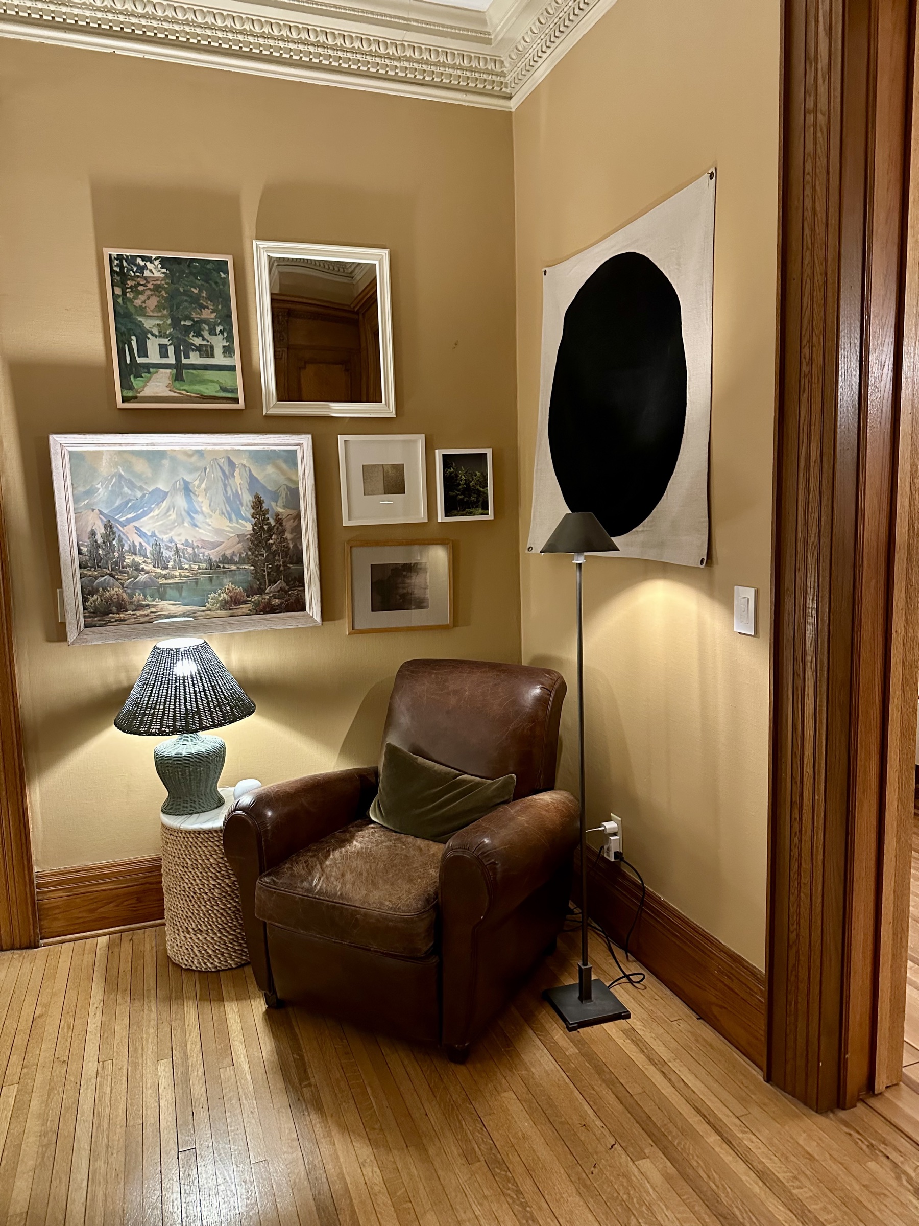 The grand foyer at 638 Summit Avenue — carved millwork, round banquette, leaded-glass overhead.