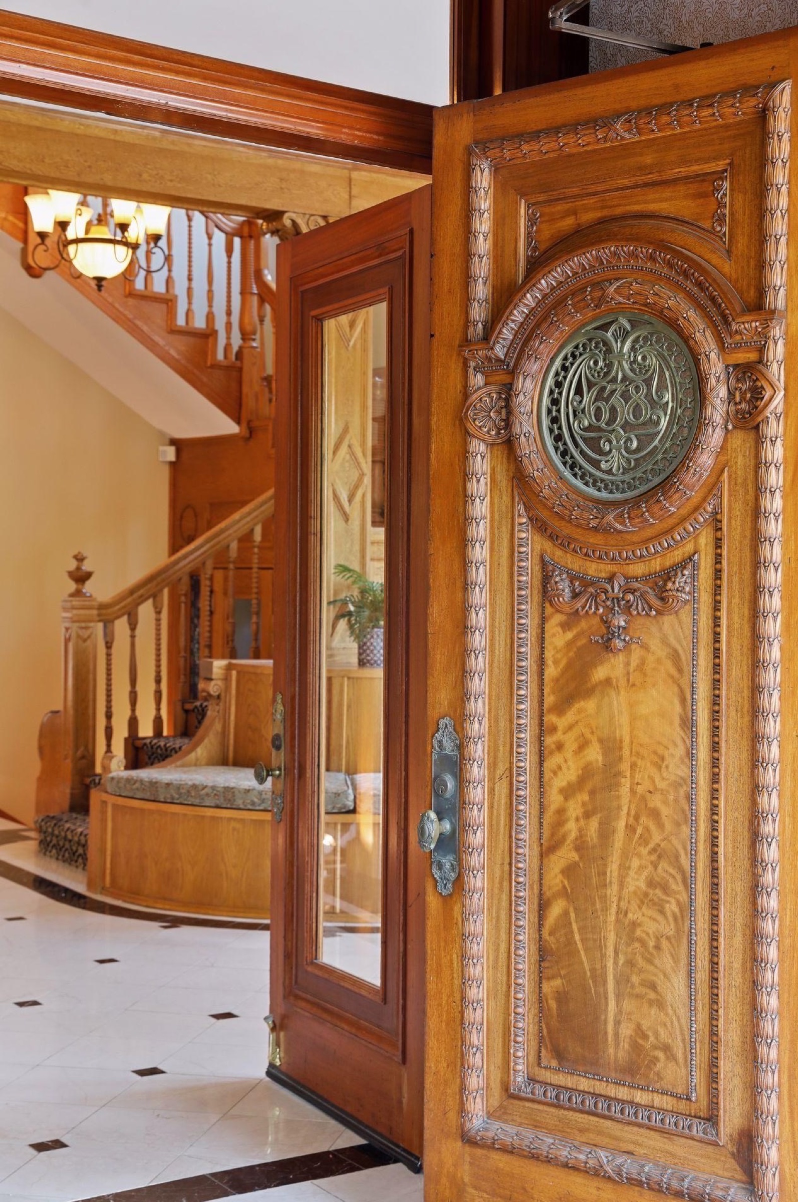 The front door of 638 Summit Avenue opens to the foyer beyond — a guest's first view of the house on arrival day.